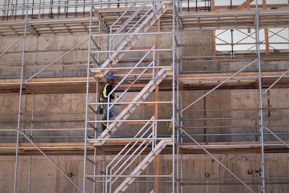 A Construction Worker Climbs Scaffolding as a Building Takes Shape on Camp Blaz