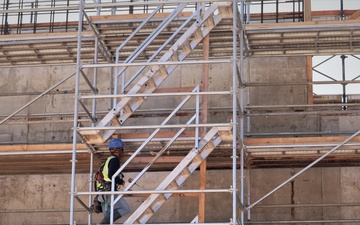 A Construction Worker Climbs Scaffolding as a Building Takes Shape on Camp Blaz