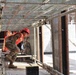 A Civil Engineering Officer Ducks Under Scaffolding While Touring a Building Under Construction on Marine Corps Base Camp Blaz