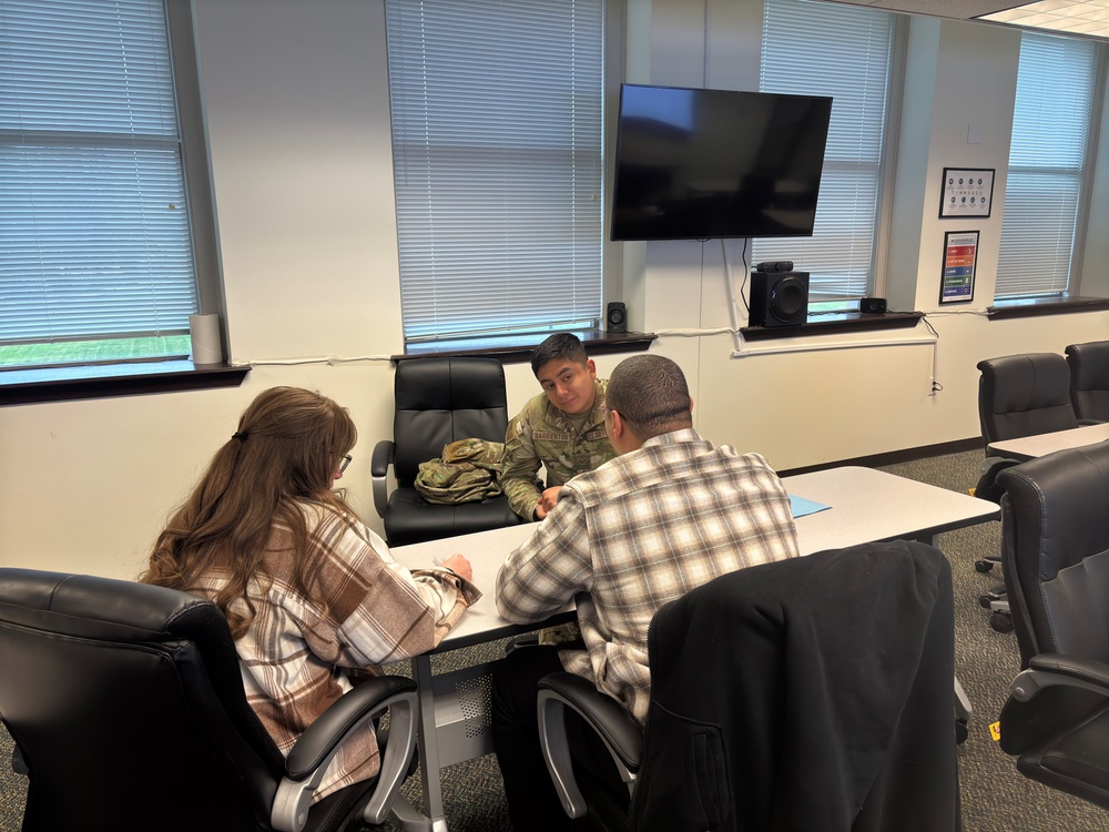 An airman and other Summit Room volunteers practice the skills from WRAIR-West’s peer ambassador training by role-playing a peer-to-peer conversation about sharing on-base resources.