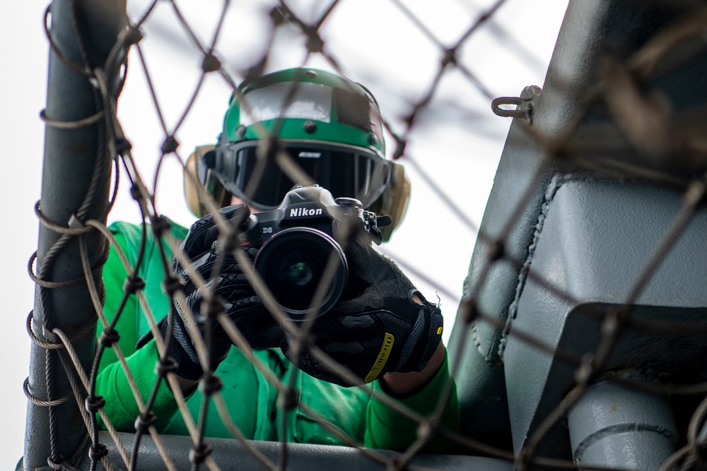 Nimitz Sailor Takes a Photograph