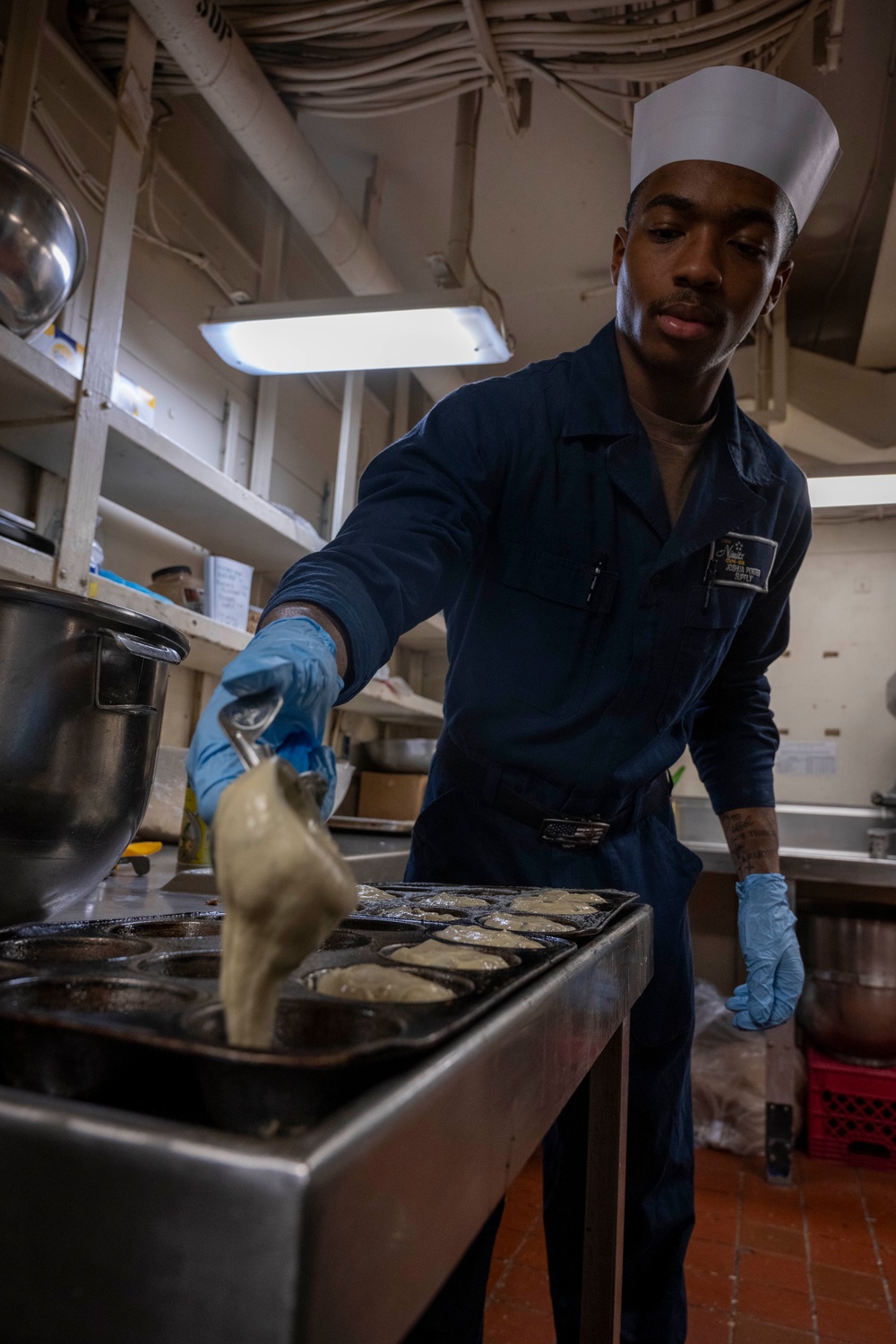 Nimitz Sailor Fills Baking Tray With Batter