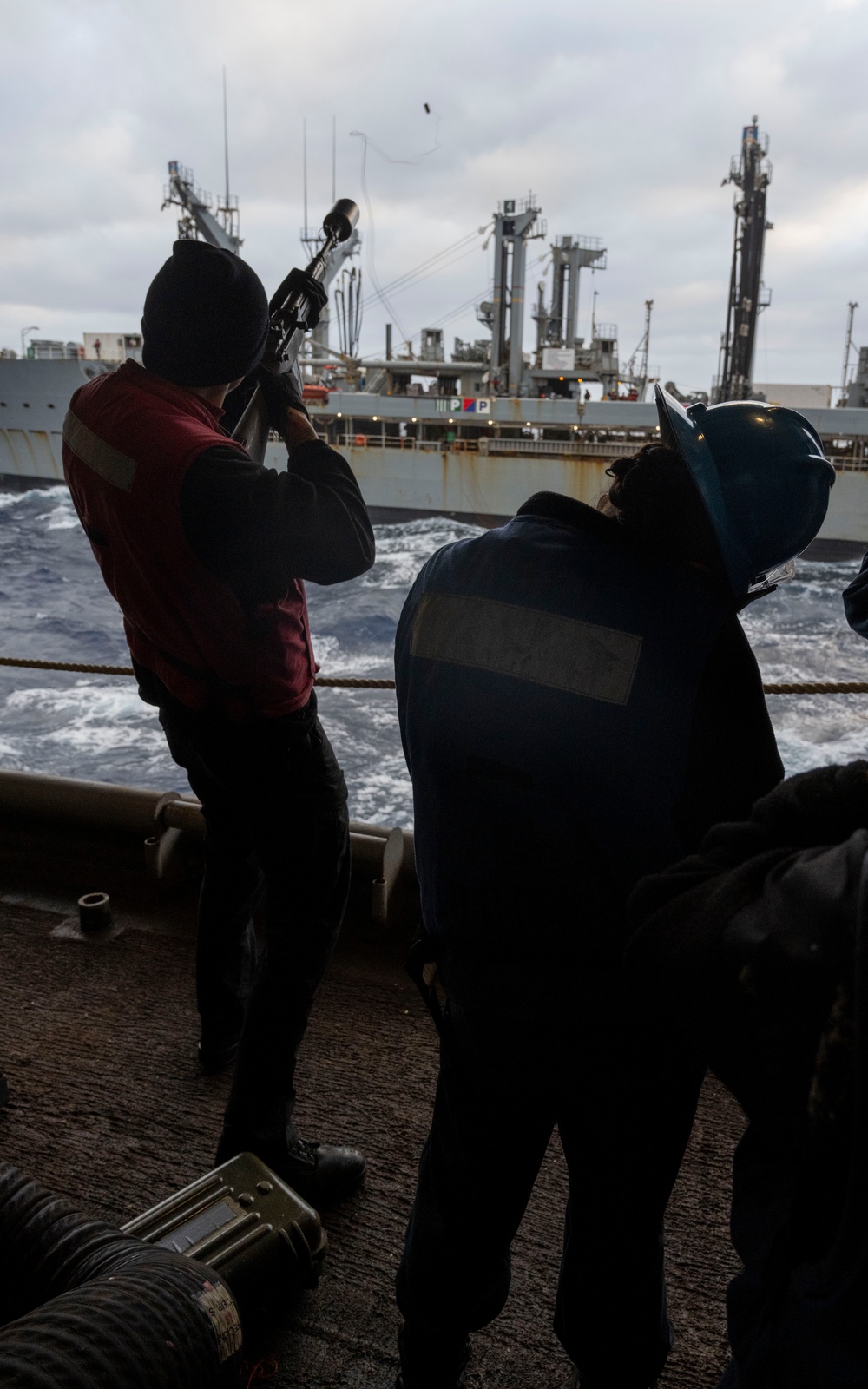 Nimitz Sailor Fires Shot Line during Refueling At Sea Evolution