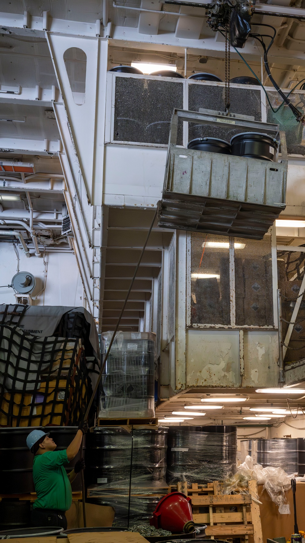 Nimitz Sailor Stabilizes Cargo During Winch Operations