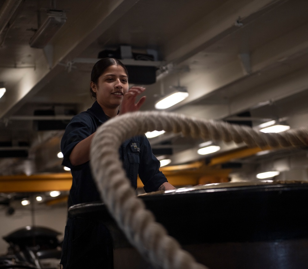 Nimitz Sailor Wraps a Line Around the Capstan