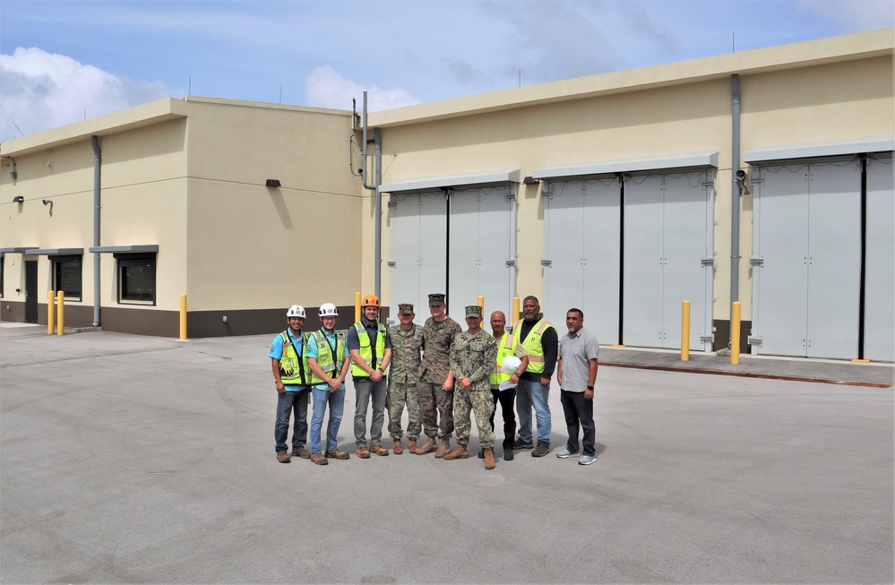 Contractors, Marines, and OICC MCM Staff Pose in Front of a Newly Completed Building on Marine Corps Base Camp Blaz