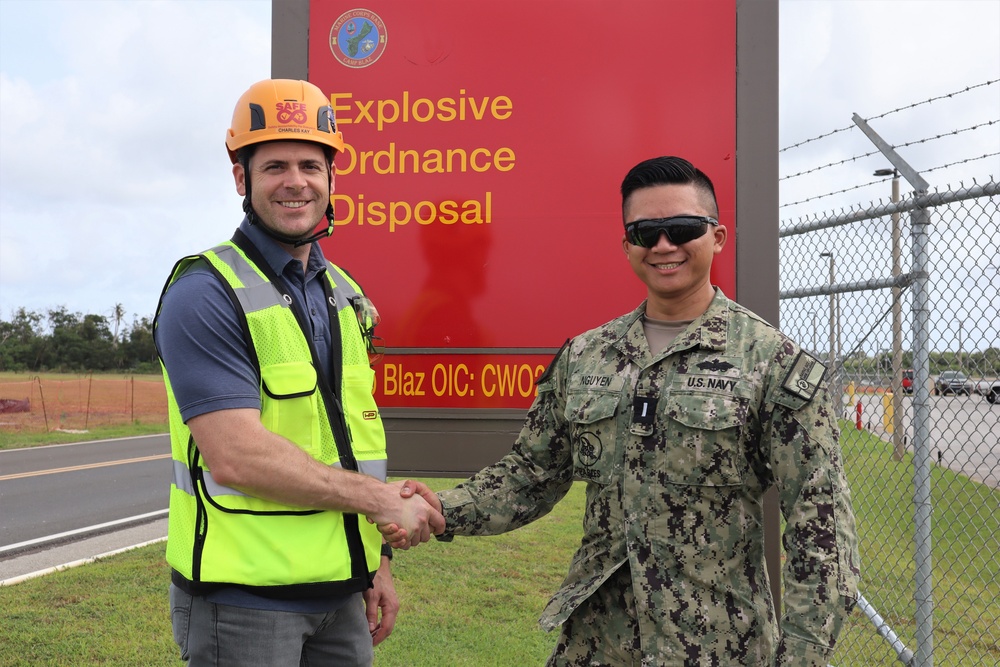 The Project Manager for the Newly-Finished EOD Building Shakes Hands with OICC MCM's Construction Manager at Building Turnover