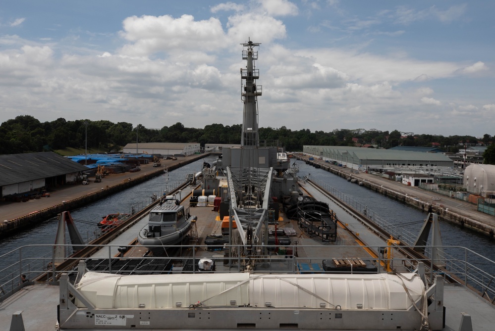 USS Emory S. Land (AS 39) departs Singapore