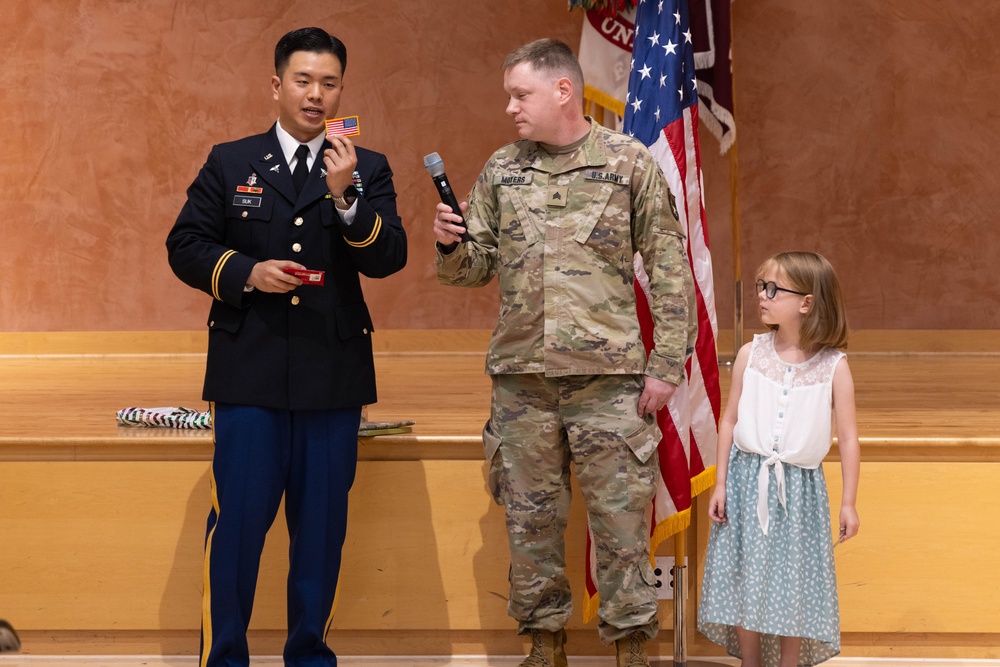 Two Soldiers are promoted during a ceremony at WRAIR