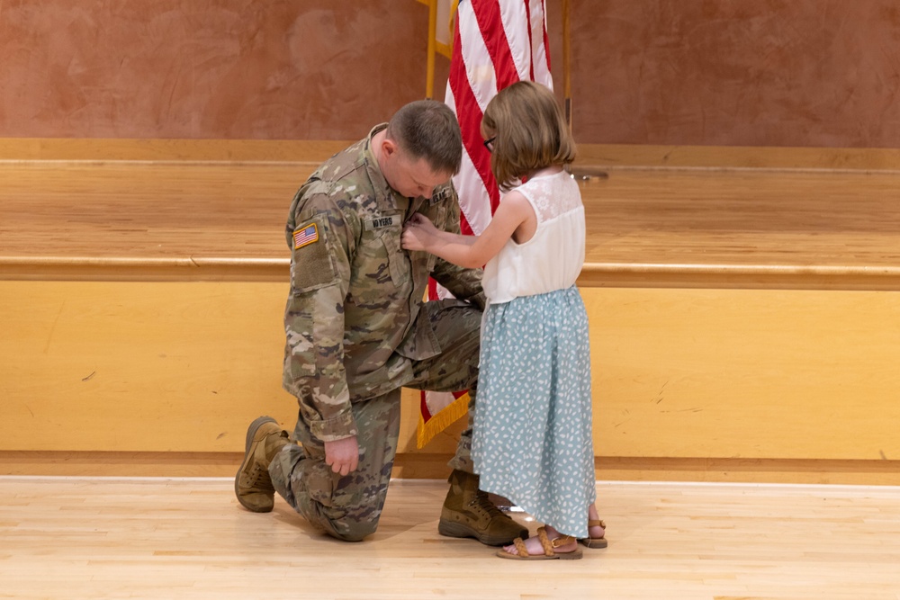 Two Soldiers are promoted during a ceremony at WRAIR