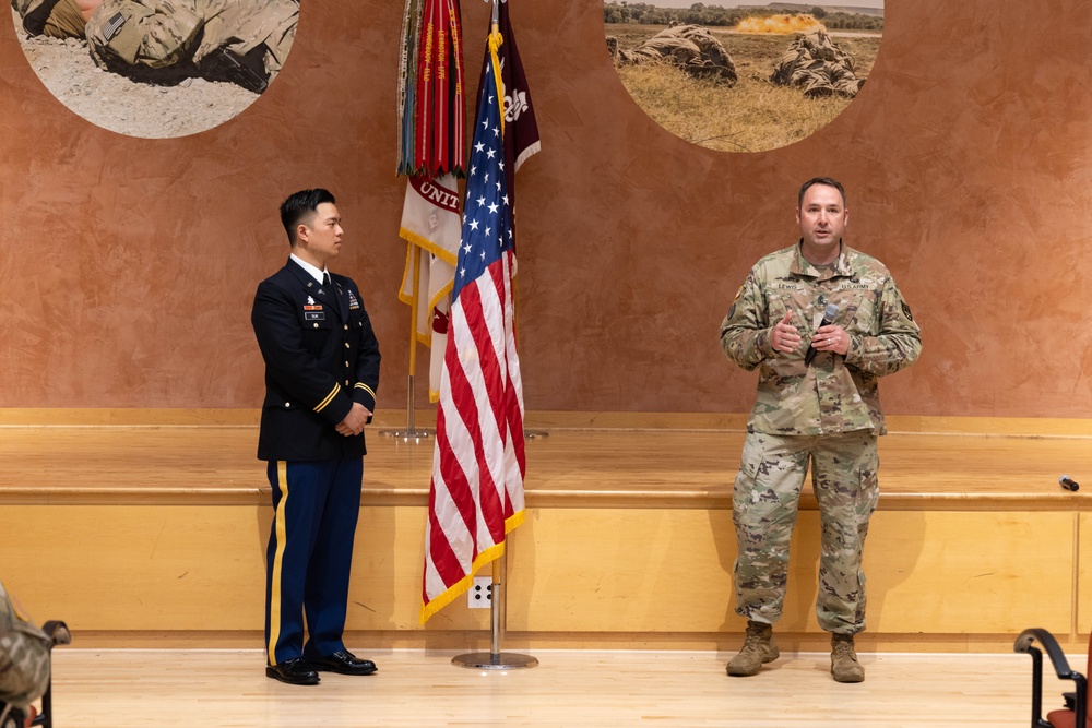 Two Soldiers are promoted during a ceremony at WRAIR