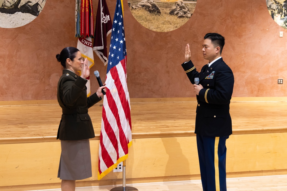 Two Soldiers are promoted during a ceremony at WRAIR