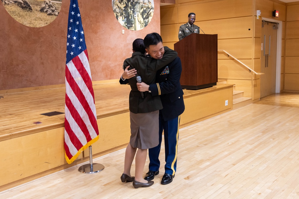 Two Soldiers are promoted during a ceremony at WRAIR