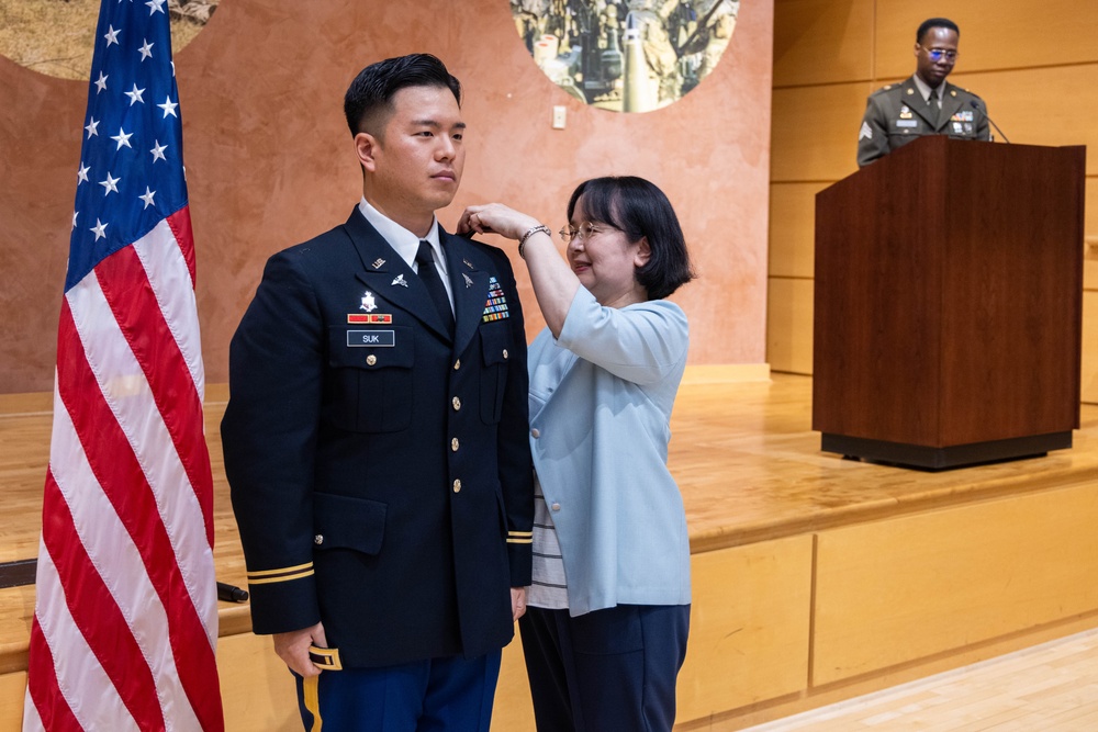 Two Soldiers are promoted during a ceremony at WRAIR
