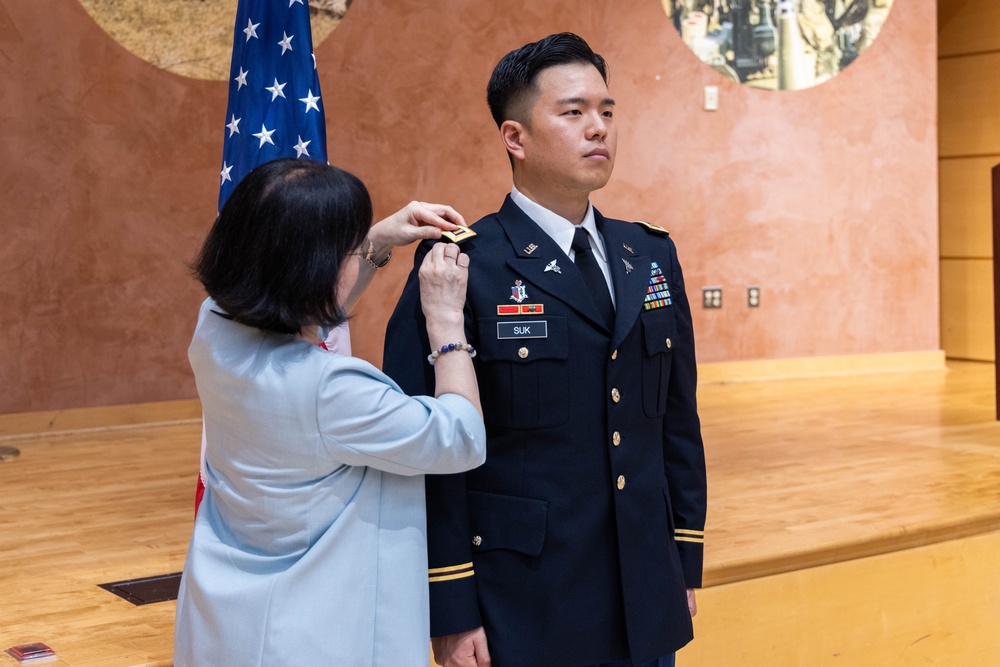 Two Soldiers are promoted during a ceremony at WRAIR