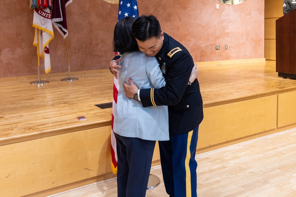 Two Soldiers are promoted during a ceremony at WRAIR