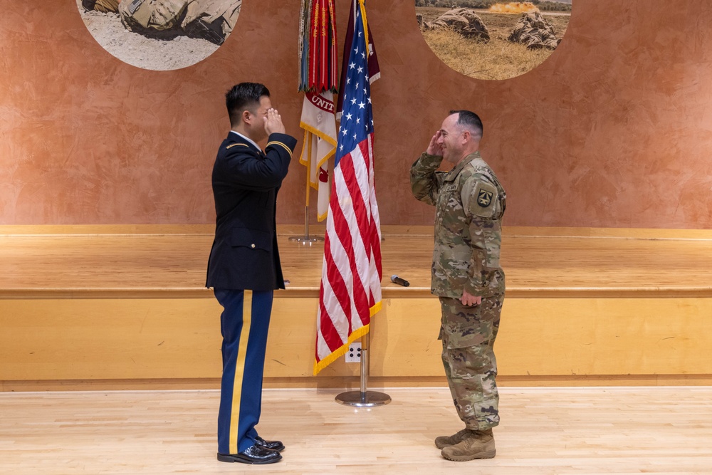 Two Soldiers are promoted during a ceremony at WRAIR