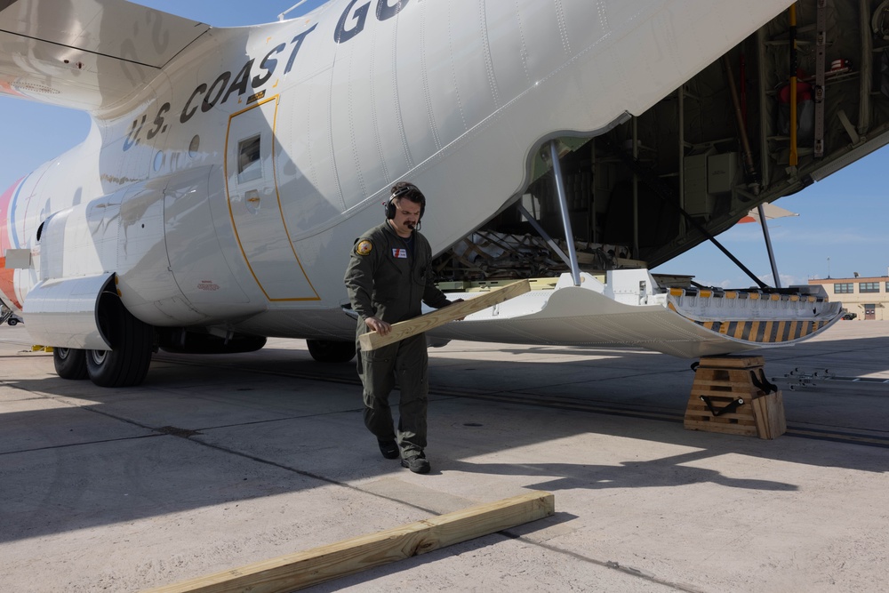 U.S. Service Members unload supplies in support of Joint Operation Southern Guard