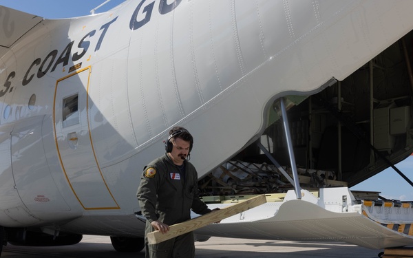 U.S. Service Members unload supplies in support of Joint Operation Southern Guard