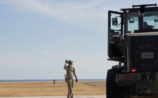 U.S. Service Members unload supplies in support of Joint Operation Southern Guard