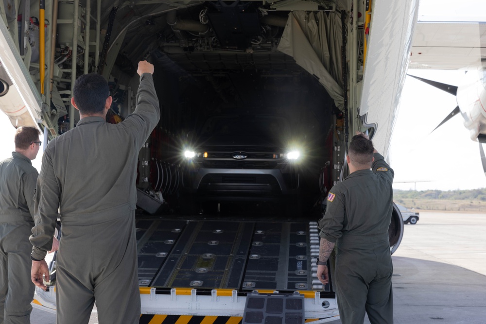 U.S. Service Members unload supplies in support of Joint Operation Southern Guard