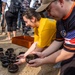 U.S. Navy Sailors release baby sea turtles into ocean during Multilateral Naval Exercise Komodo 2025 community relations project