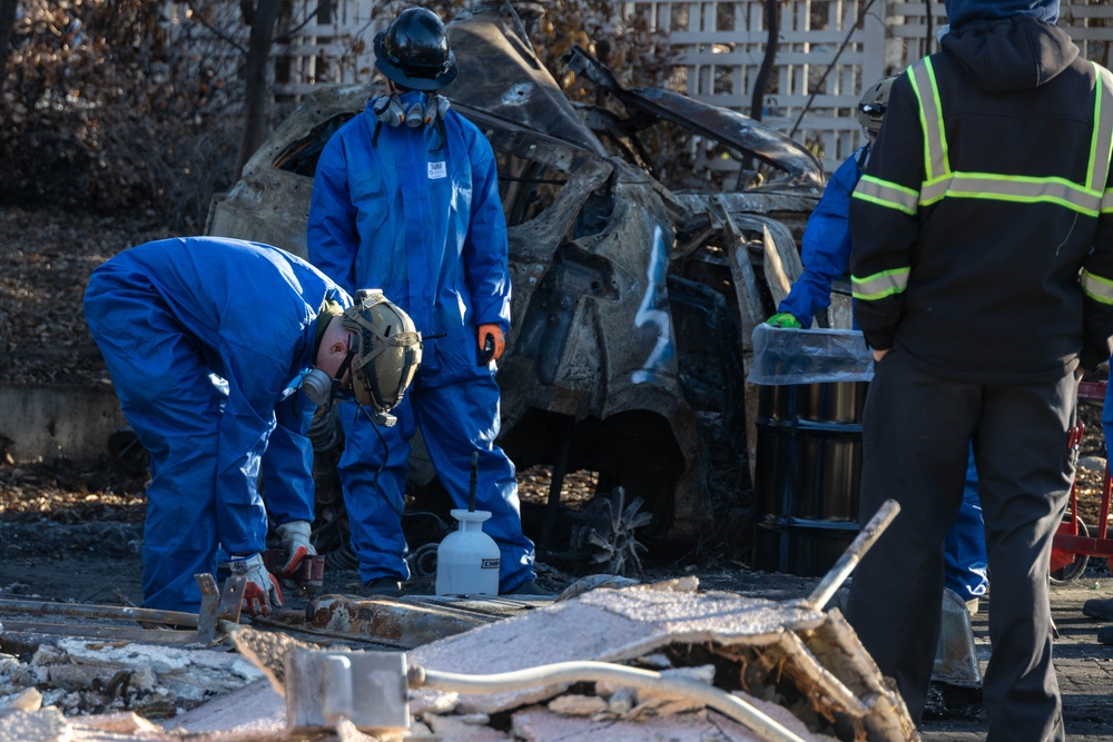 Day 5: U.S. service members dispose of burned batteries.