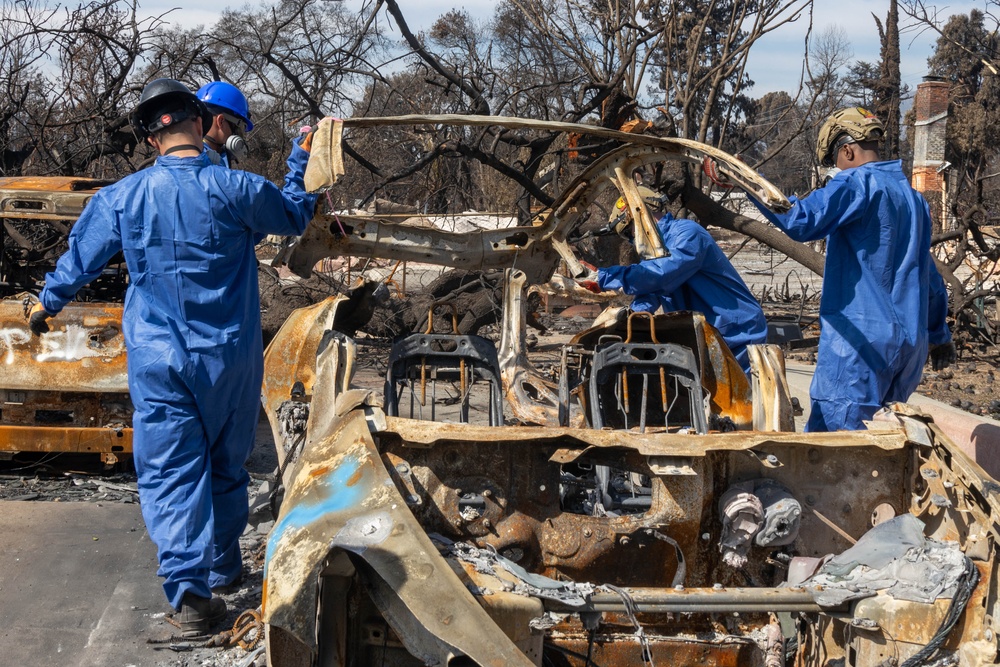 Day 5: U.S. service members dispose of burned batteries.