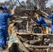 Day 5: U.S. service members dispose of burned batteries.