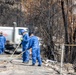 Day 5: U.S. service members dispose of burned batteries.