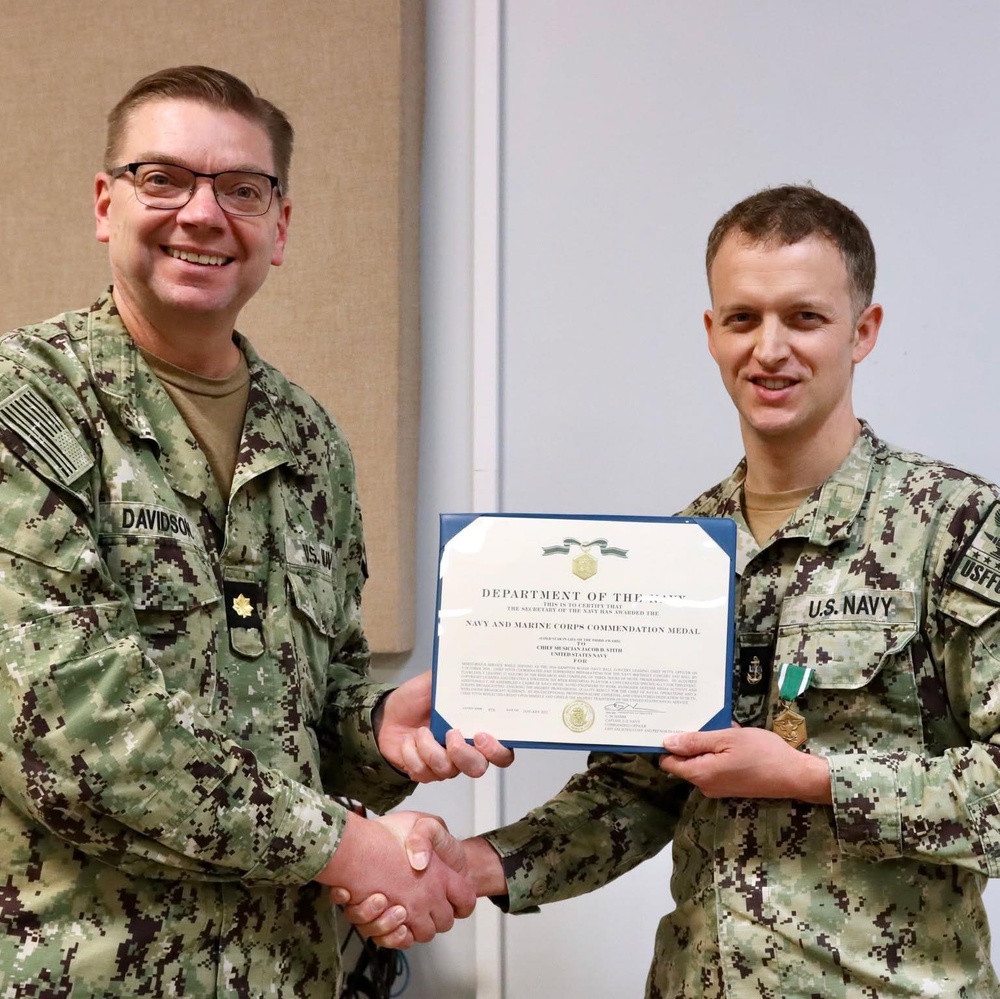 Chief Musician Jacob Stith receives the Navy and Marine Corps Commendation Medal