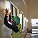 A Contractor Checks the Installation of a Light Fixture in the New Dining Facility on Camp Blaz