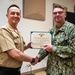 Musician First Class Michael Buenvenida receives the Navy and Marine Corps Achievement Medal