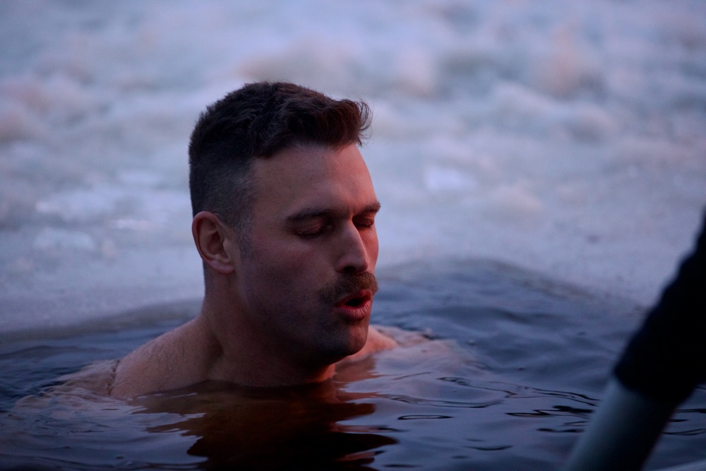 Virginia National Guard Soldiers participate in Finnish past-time of “avanto” or ice-hole swimming during Arctic Forge 25