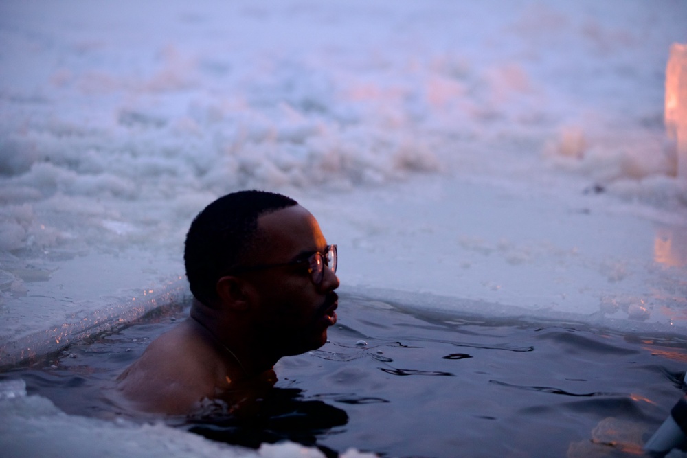 Virginia National Guard Soldiers participate in Finnish past-time of “avanto” or ice-hole swimming during Arctic Forge 25