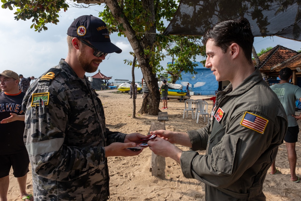 U.S. Navy Sailors release baby sea turtles into ocean during Multilateral Naval Exercise Komodo 2025 community relations project