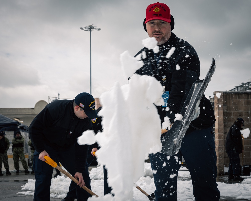 USS Gerald R. Ford (CVN 78) Sailors shovel snow during a winter storm
