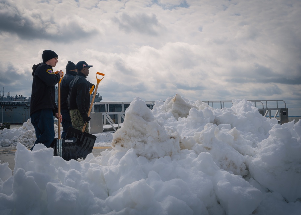 USS Gerald R. Ford (CVN 78) Sailors shovel snow during a winter storm