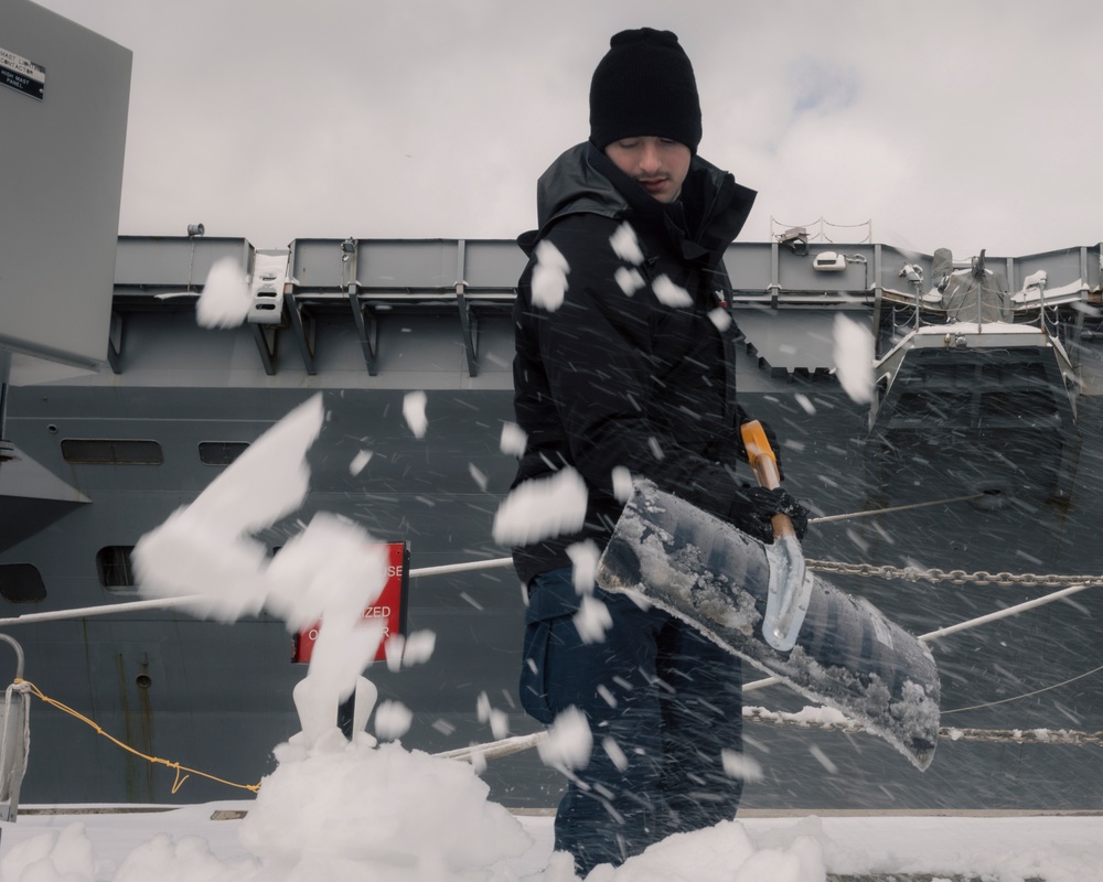 USS Gerald R. Ford (CVN 78) Sailors shovel snow during a winter storm