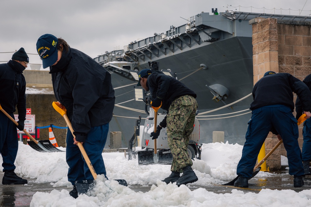 USS Gerald R. Ford (CVN 78) Sailors shovel snow during a winter storm