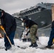 USS Gerald R. Ford (CVN 78) Sailors shovel snow during a winter storm