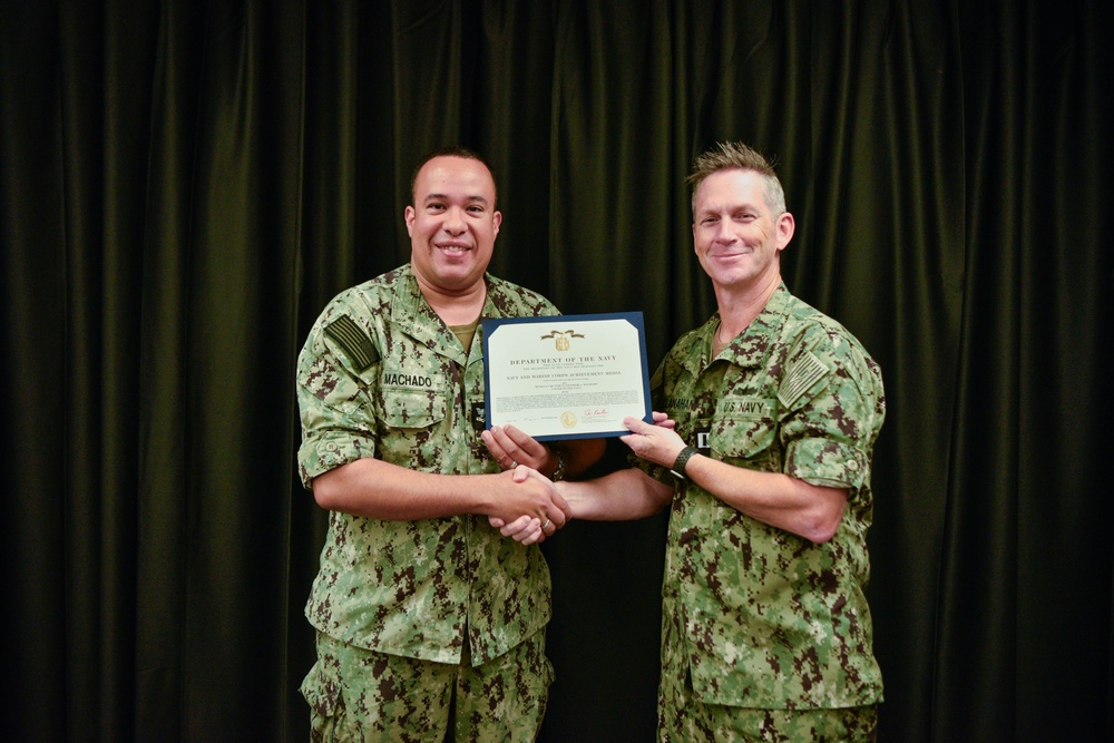 LT Clint McClanahan presents MU2 Omar Machado-Rios with Navy and Marine Corps Achievement Medal