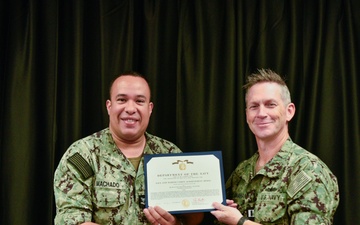 LT Clint McClanahan presents MU2 Omar Machado-Rios with Navy and Marine Corps Achievement Medal