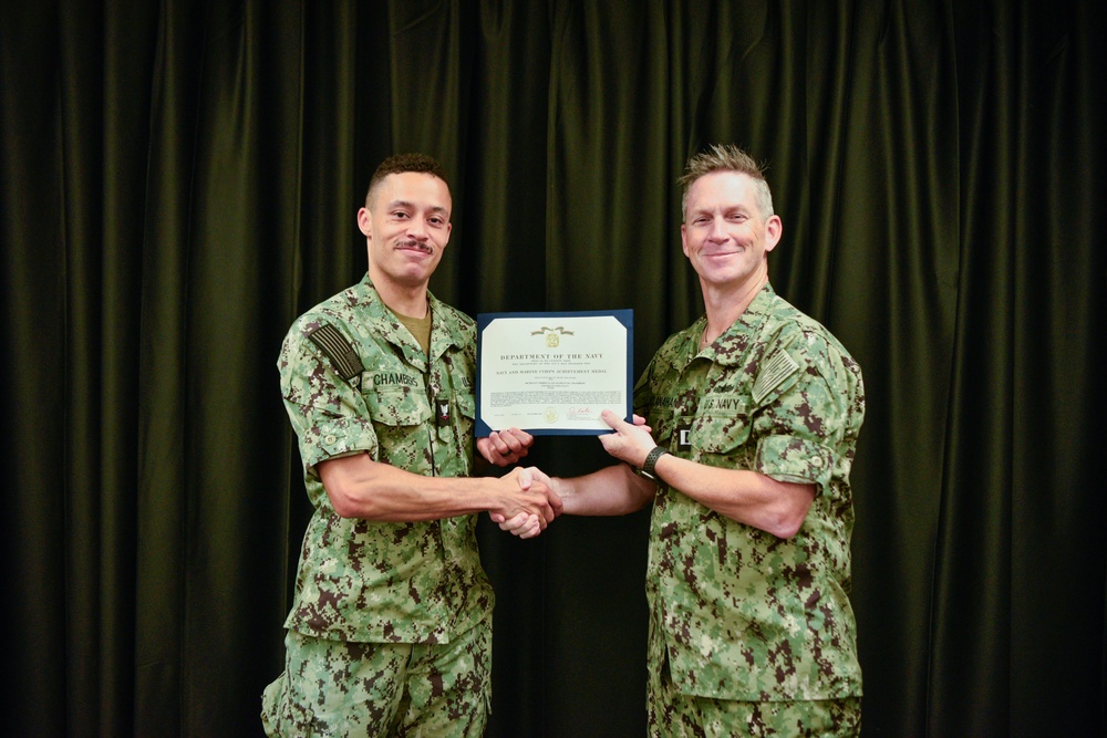 LT Clint McClanahan presents MU3 Damian Chambers with Navy and Marine Corps Achievement Medal