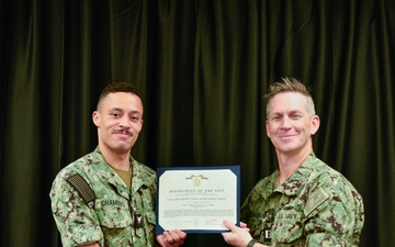 LT Clint McClanahan presents MU3 Damian Chambers with Navy and Marine Corps Achievement Medal