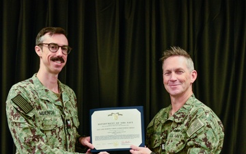 LT Clint McClanahan presents MU3 Erik Muench with Navy and Marine Corps Achievement Medal for his support of Pacific Partnership 2024-2