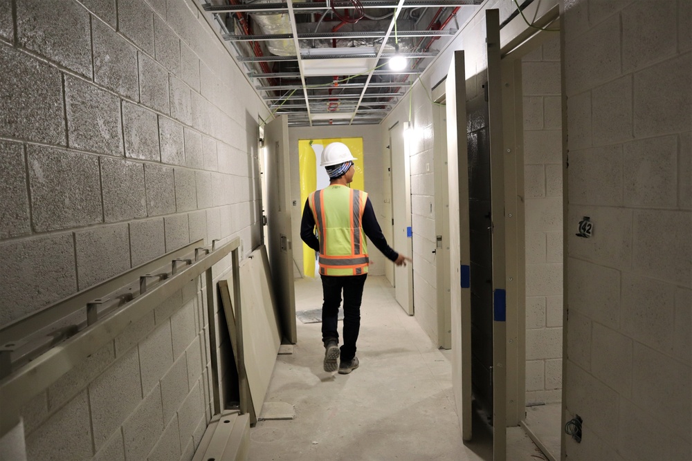 A Contractor Walks Through a Police Station Under Construction on Camp Blaz