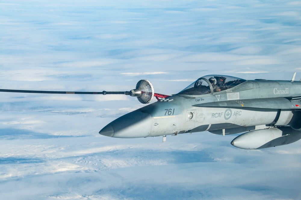 CF-18 Hornet and CC-150 Polaris from the Canadian NORAD Region carry out air-to-air refueling