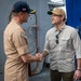Secretary of Defense Pete Hegseth interacts with Sailors