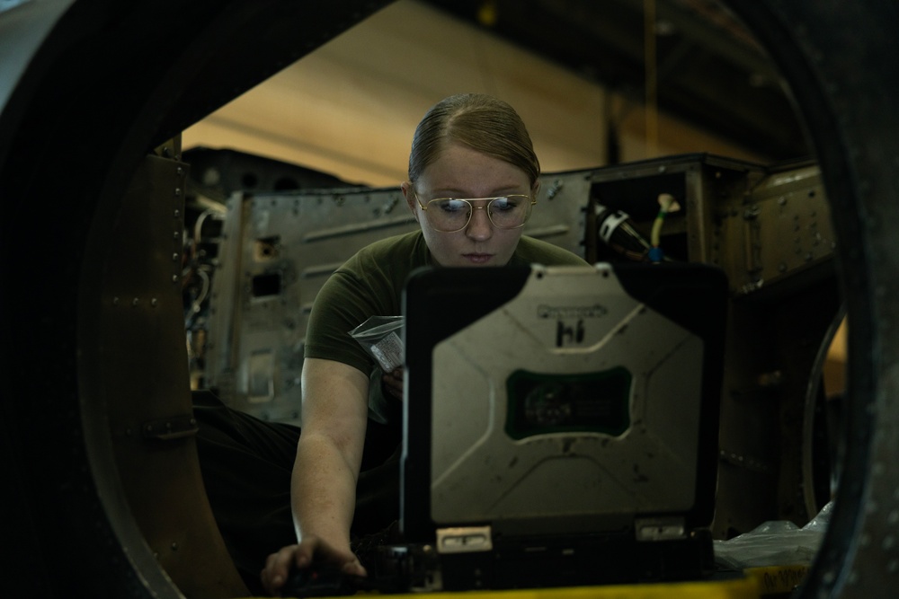 U.S. Marines with VMA-231 conduct maintenance on the AV-8B Harrier II